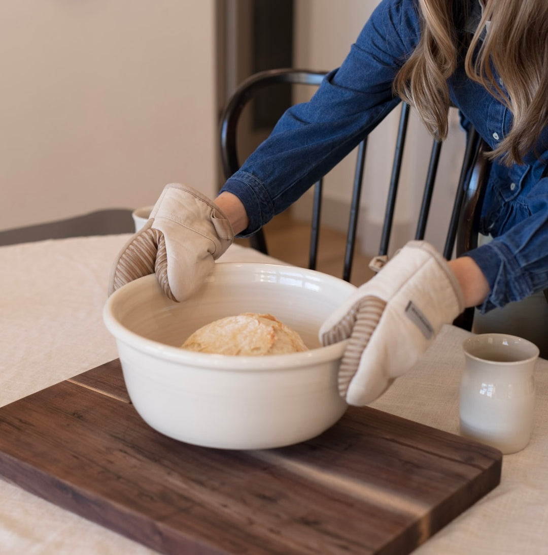 Serving freshly made sourdough bread in beautiful ceramic bakeware.