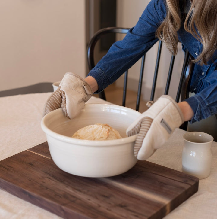 Serving freshly made sourdough bread in beautiful ceramic bakeware.